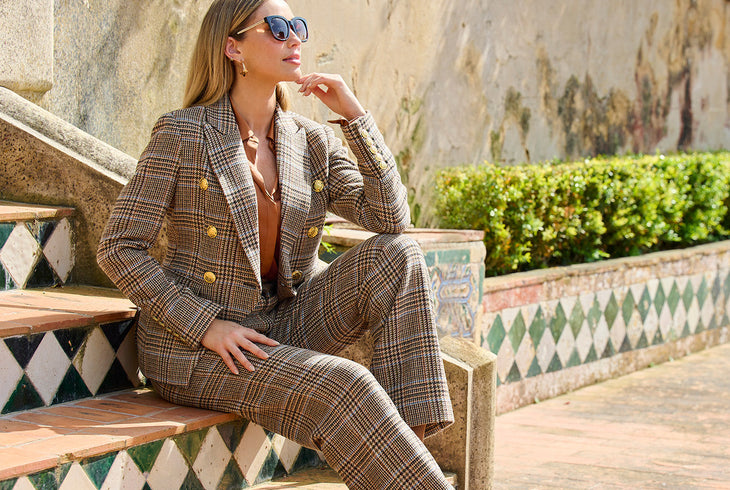 model wearing a brown plaid blazer, brown plaid trousers, and a brown charmeuse blouse.