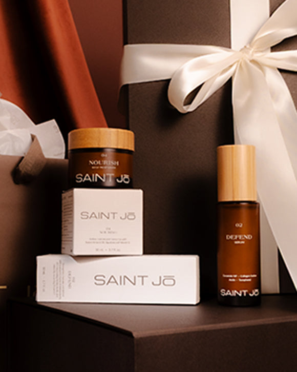 SAINT JO skincare products with a decorative box on a dark surface