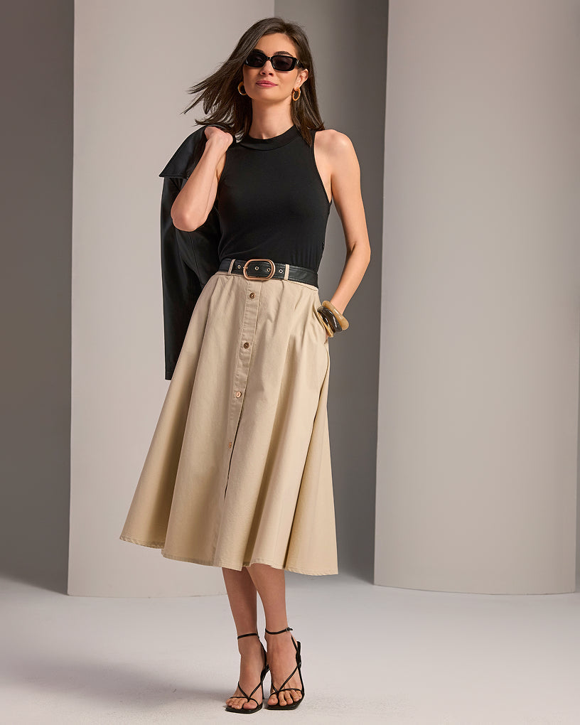 model wears black and tan midi dress