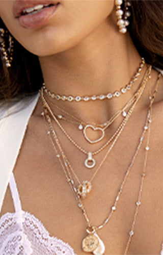 Model is wearing Ettika jewelry