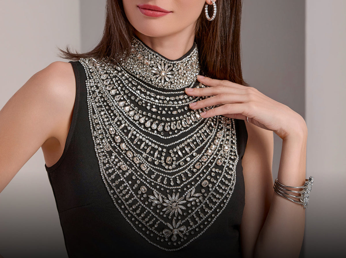 model wears embellished high neck black top