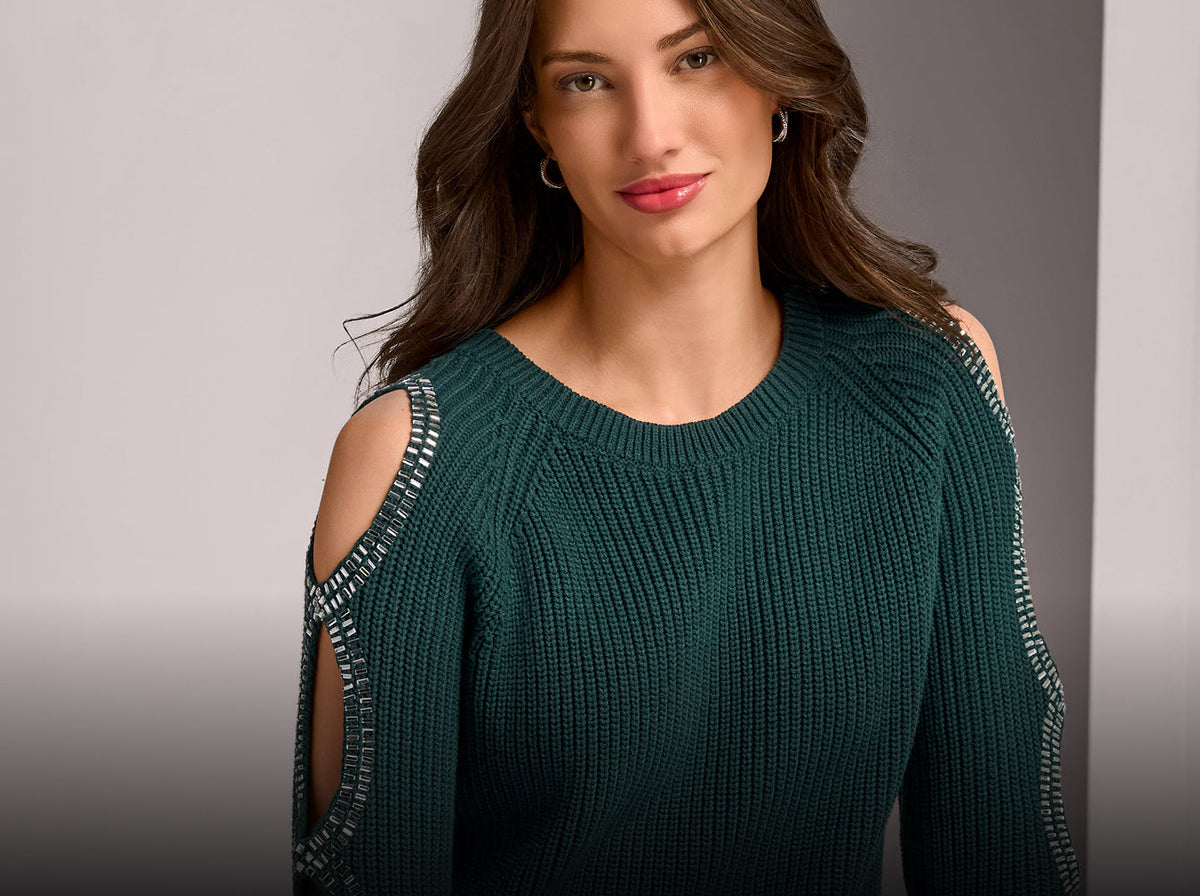model wears embellished green sweater