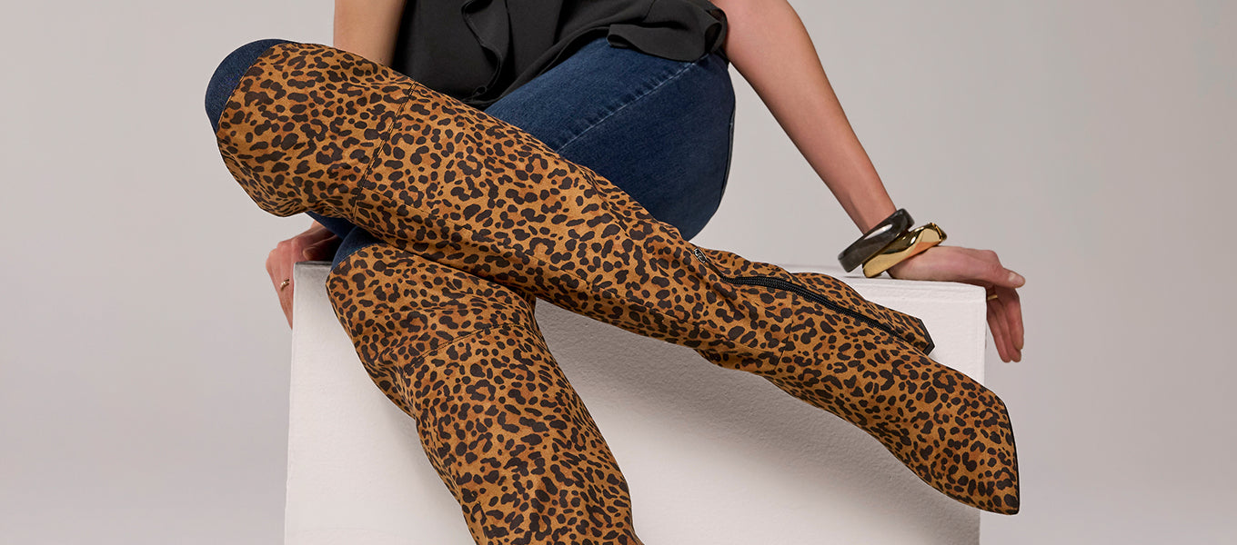 models wearing cheetah knee high boots
