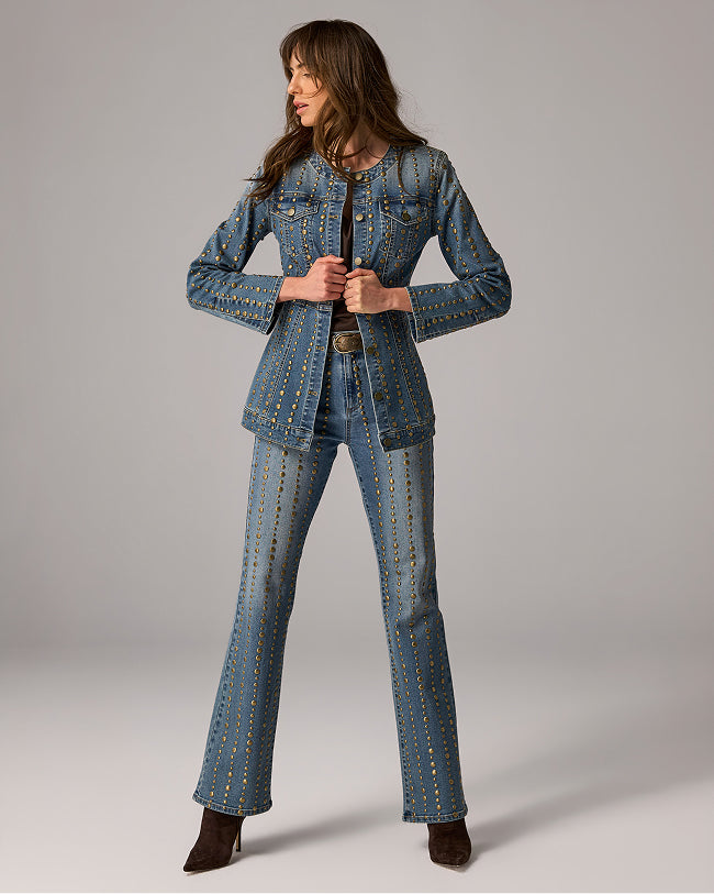 model wears studded denim jacket and jeans