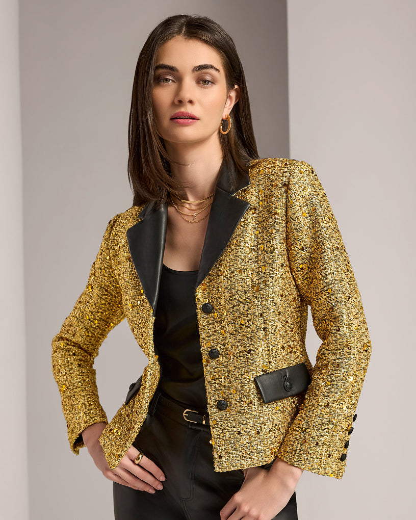 model wears gold and black blazer