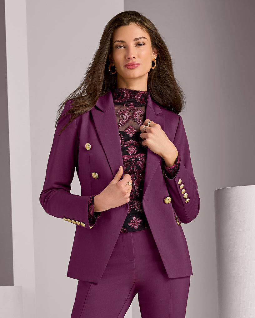 model wears plum colored suit set