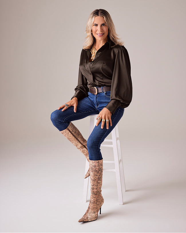 sheryl wears brown blouse and denim