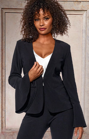 Model wearing a black flare-sleeve blazer, white v-neck top, and black pants.