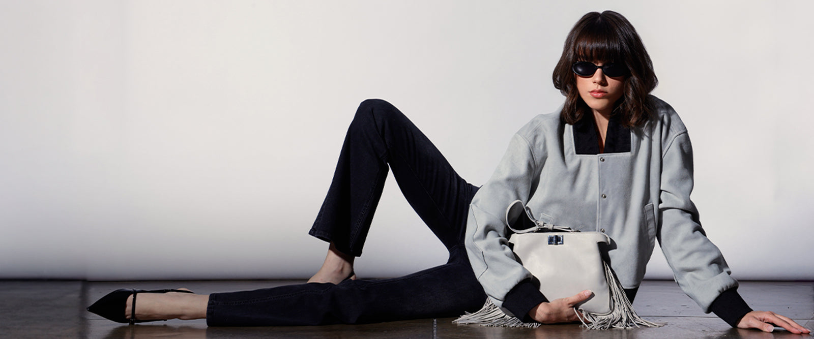 Models wearing a grey jacket and black pants