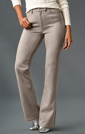 Model wearing off white sweater, light grey monterey bootcut jeans and silver metallic square toe booties.