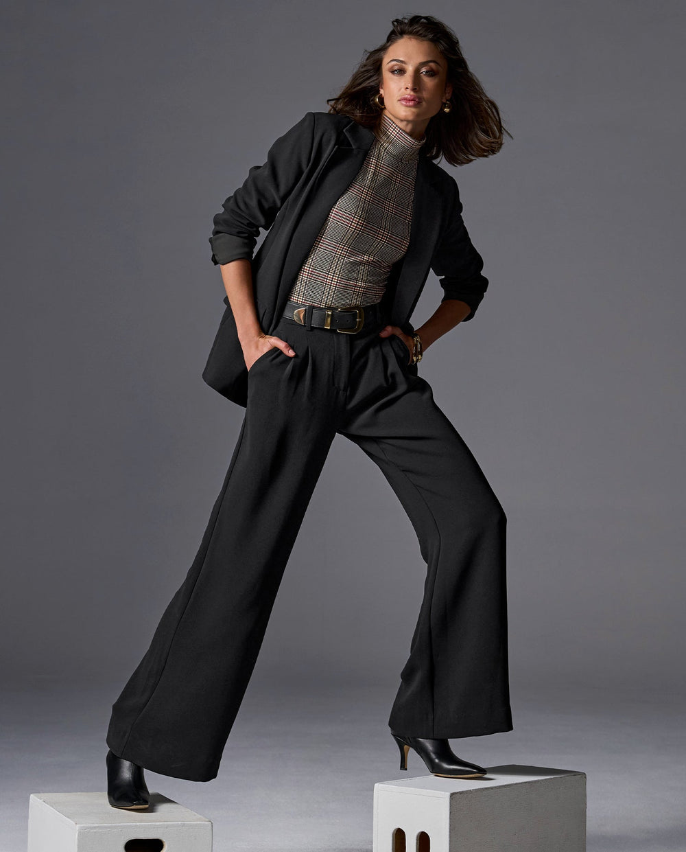 Model is wearing black blazer and trousers