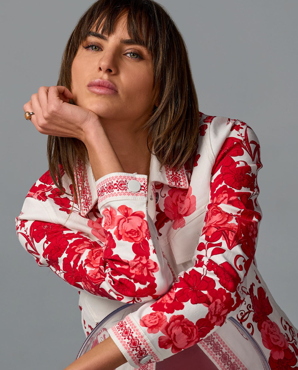 Model is wearing red and white floral jacket