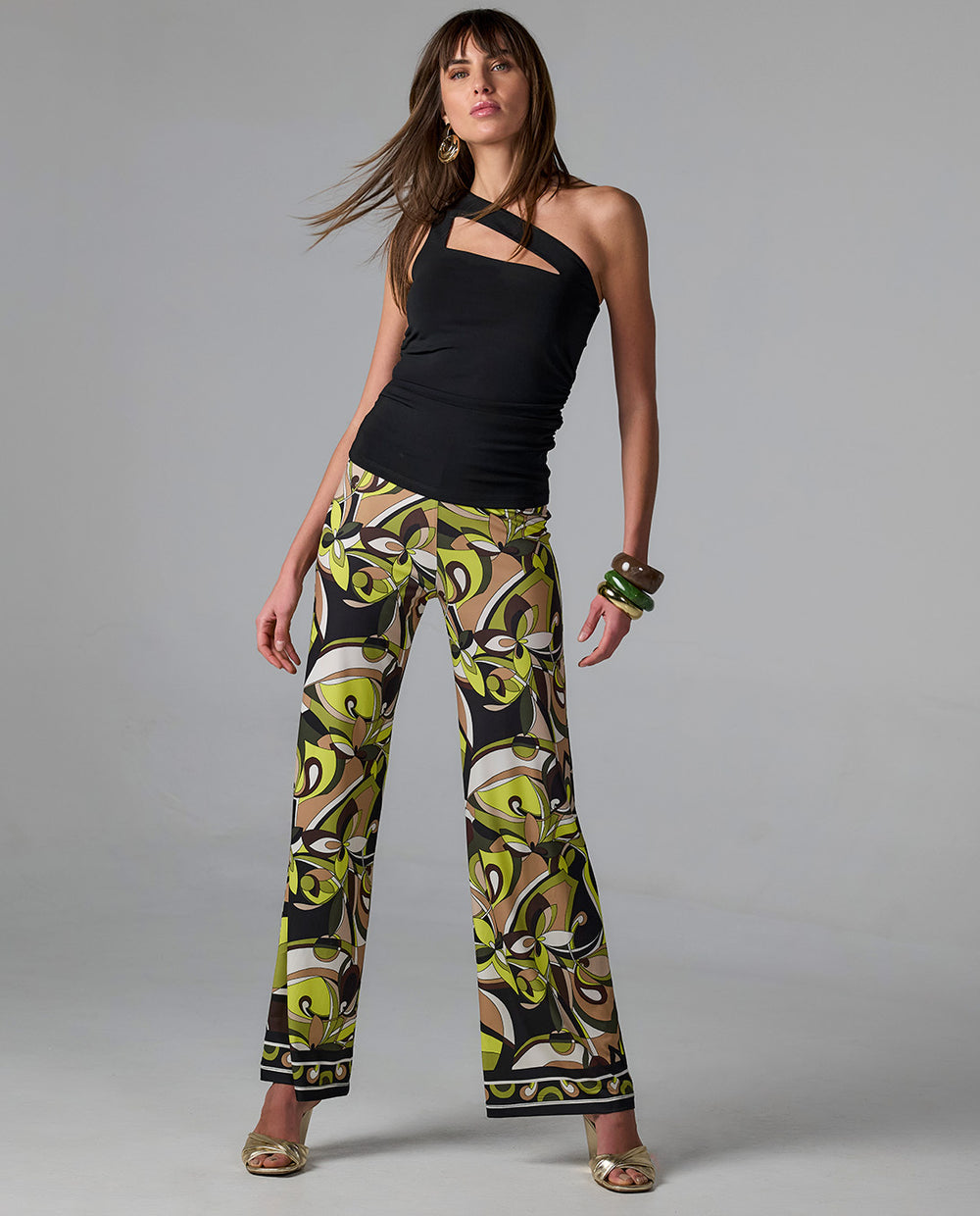 model is wearing cut out black tank with abstract pants