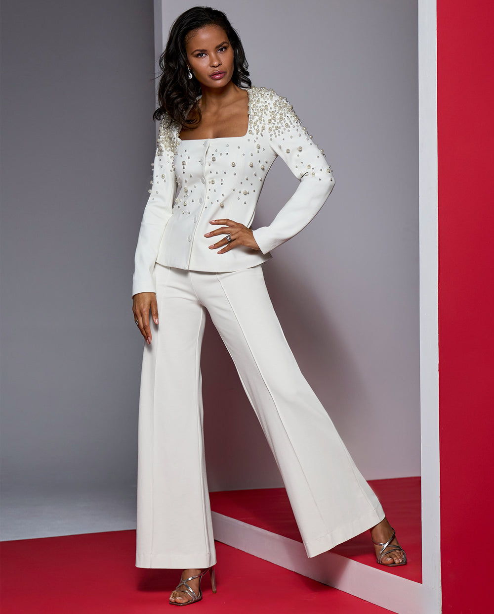 Models wearing white embellished blazer style top