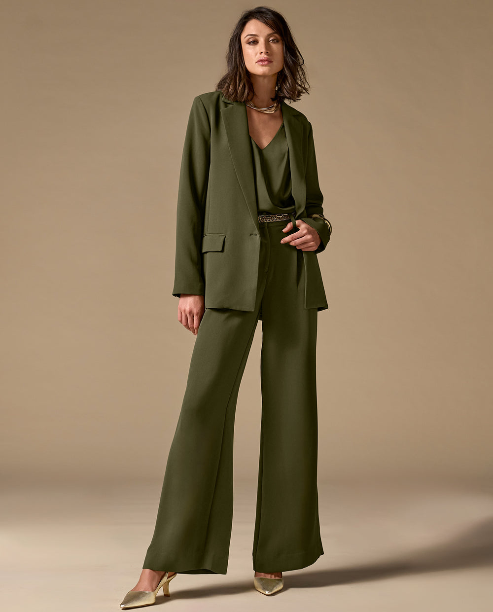 Model is wearing olive green matching suit set.