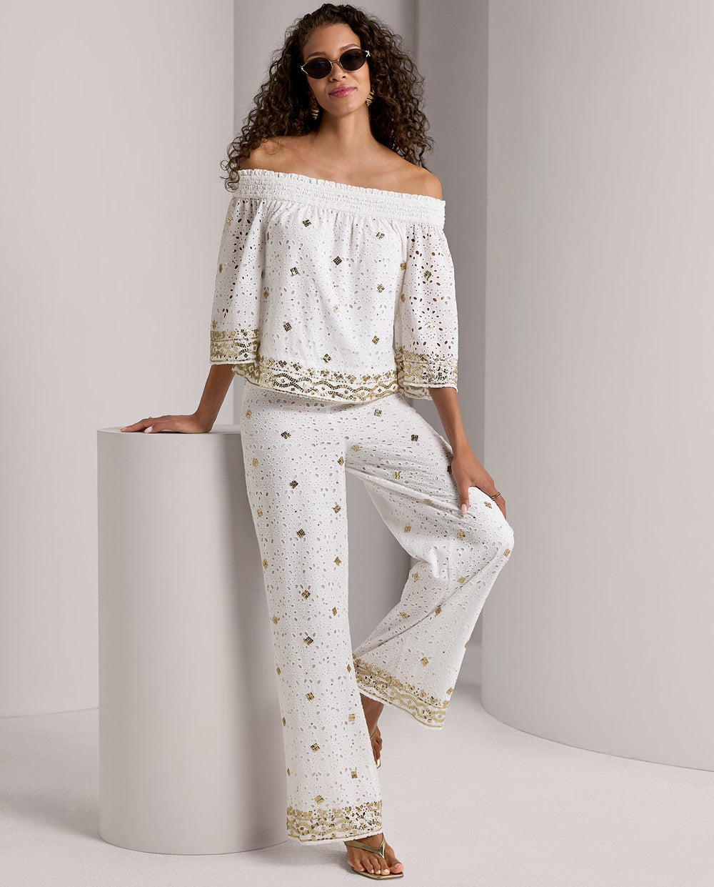 models wearing white and gold matching off the shoulder top and pants