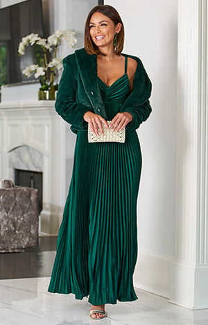 Model wearing emerald green floor length dress with emerald green plush jacket.