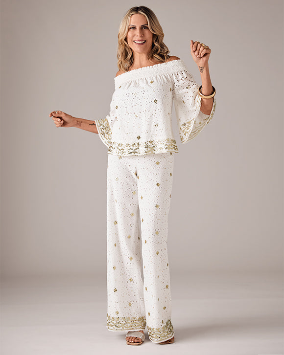 sheryl wears white and gold matching set