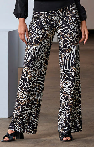 Model wearing black blouse with animal print Beyond Travel Palazzo Pant with heels.